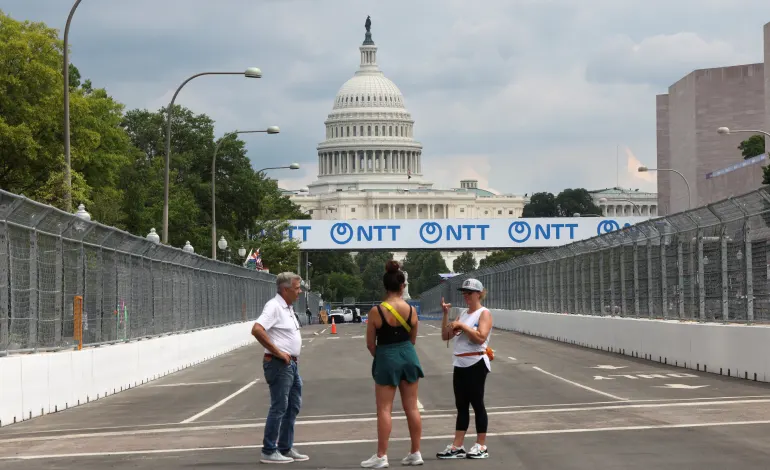 People stand on a stretch of Pennsylvania Avenue that has been transformed into a section of race track for this weekend's Freedom 250 Grand Prix IndyCar series race near the U.S. Capitol in Washington, D.C., U.S., August 18, 2026. REUTERS/Kevin Lamarque