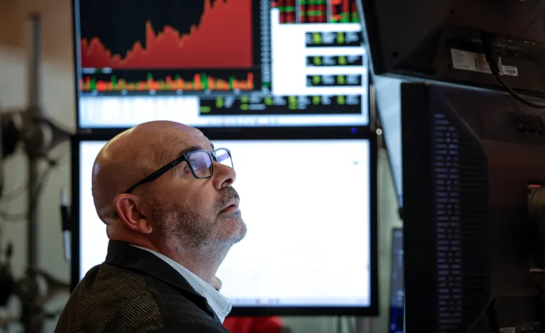 A trader works on the floor of the New York Stock Exchange (NYSE) in New York City, U.S., August 18, 2026. Jeenah Moon