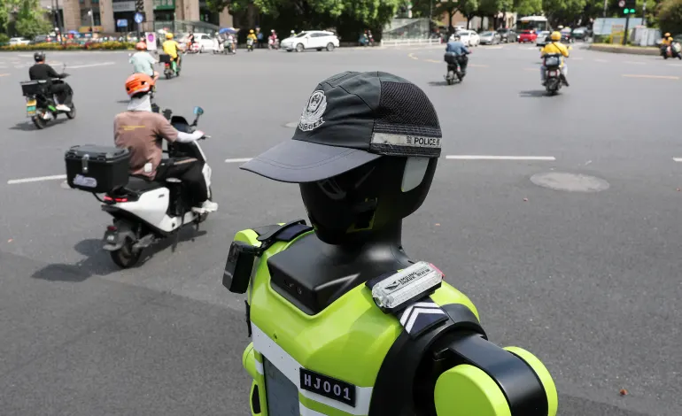 A humanoid robot traffic police officer developed by SUPCON stands on duty on a street in Hangzhou, Zhejiang province, China, July 21, 2026. REUTERS/Go Nakamura