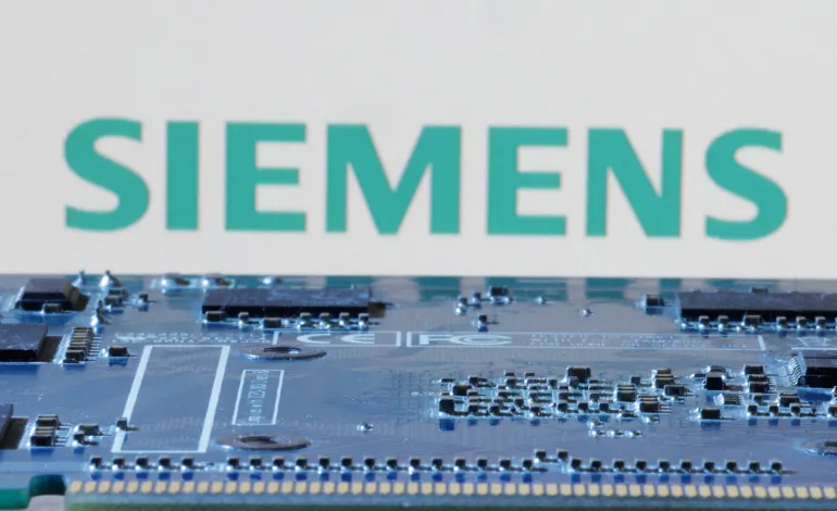 Siemens logo is seen near computer motherboard in this illustration taken January 8, 2024. Dado Ruvic/Illustration