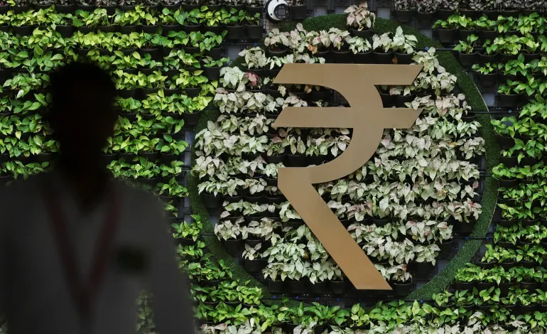 A man walks past an Indian Rupee symbol installation at the Reserve Bank of India (RBI) headquarters in Mumbai, India, August 5, 2026. Francis Mascarenhas