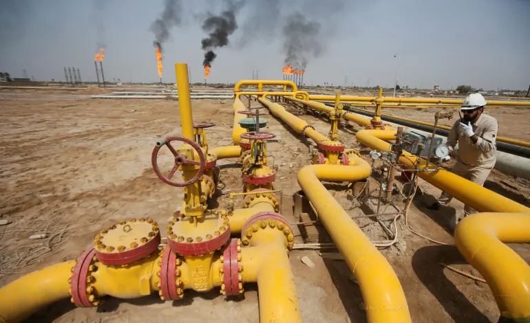 A worker checks an oil pipeline at Nahr Bin Umar oil field, north of Basra, Iraq March 22, 2022. Essam Al-Sudani