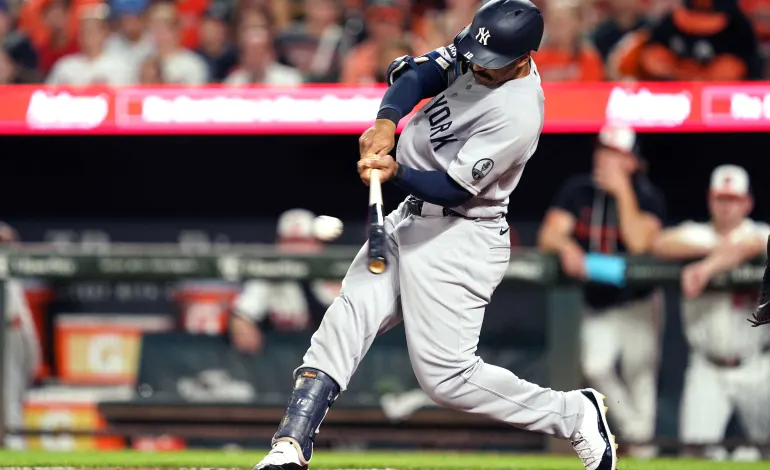 Aug 18, 2026; Baltimore, Maryland, USA; New York Yankees outfielder Trent Grisham (12) connects for a single to drive in to runs during the seventh inning against the Baltimore Orioles at Oriole Park at Camden Yards. Mandatory Credit: Mitch Stringer-Imagn Images