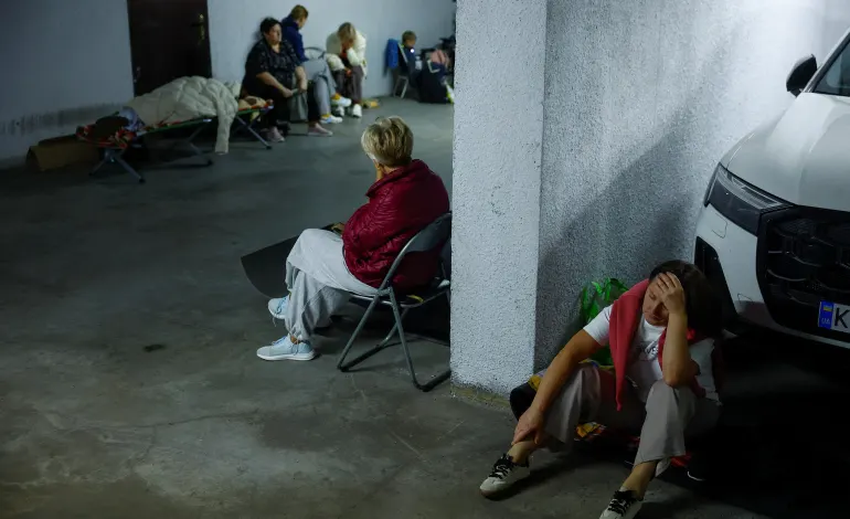 People take shelter inside an underground parking during Russian missile and drone strikes, amid Russia's attack on Ukraine, in Kyiv, Ukraine August 20, 2026. REUTERS/Valentyn Ogirenko