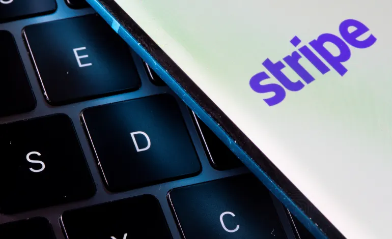 A smartphone with the Stripe logo is placed on a laptop in this illustration taken on July 14, 2021. Dado Ruvic/Illustration