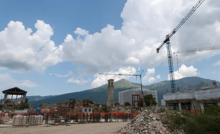 The civic clock tower stands near destroyed buildings and rubble in the red zone ten years after an earthquake devastated Amatrice, central Italy, August 8, 2026. REUTERS/Crispian Balmer