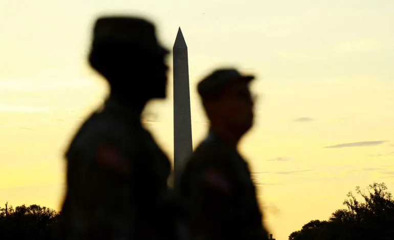 U.S. military members walk near the Washington Monument, after U.S. President Donald Trump announced the federal takeover of the Metropolitan Police Department under the Home Rule Act and the deployment of the National Guard to assist in crime prevention in the nation's capital, in Washington, D.C., August 14, 2025. REUTERS/Jose Luis Gonzalez