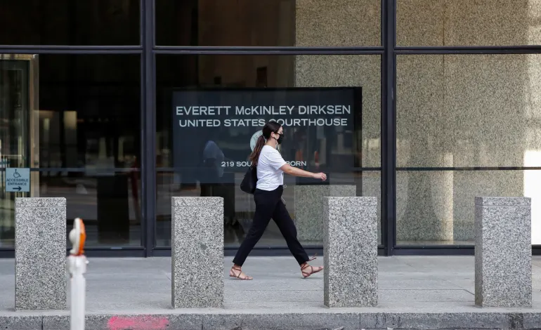 A woman walks past the Everett McKinley Dirksen U.S. Courthouse in Chicago, Illinois, U.S. July 23, 2020. Kamil Krzaczynski