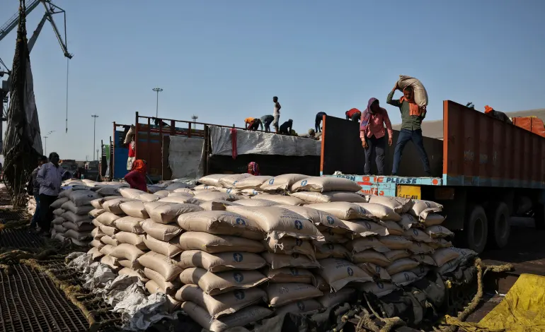 Workers unload sacks of sugar from trucks and place them in a net to be loaded onto a cargo ship at the Deendayal Port in Kandla, in the western state of Gujarat, India, April 5, 2025. Amit Dave