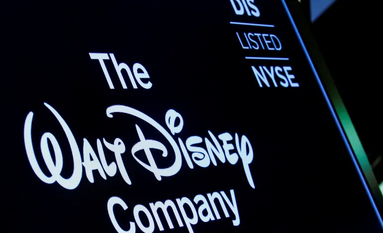 A screen shows the logo and a ticker symbol for The Walt Disney Company on the floor of the New York Stock Exchange (NYSE) in New York, U.S., December 14, 2017. Brendan McDermid