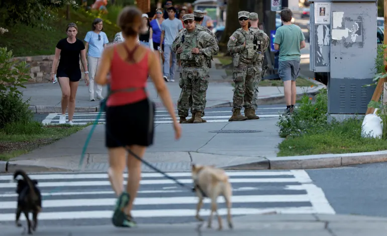 National Guard troops stand back-to-back as they wait to cross the street while on patrol following the U.S. ‌Justice Department's May announcement of planned "summer surge" of law enforcement in Washington, D.C., U.S., June 24, 2026. REUTERS/Leah Millis